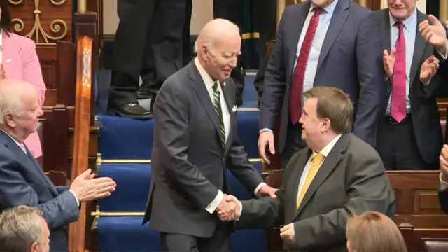 Joe Biden shakes the hand of an audience member in the Irish parliament