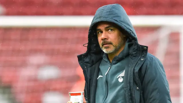 Norwich City boss David Wagner has his hood up at a rainy Riverside Stadium