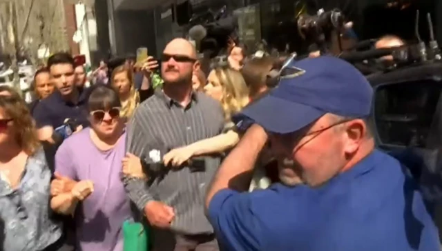 Jack Teixeira's father leaves a court in Boston - surrounded by reporters