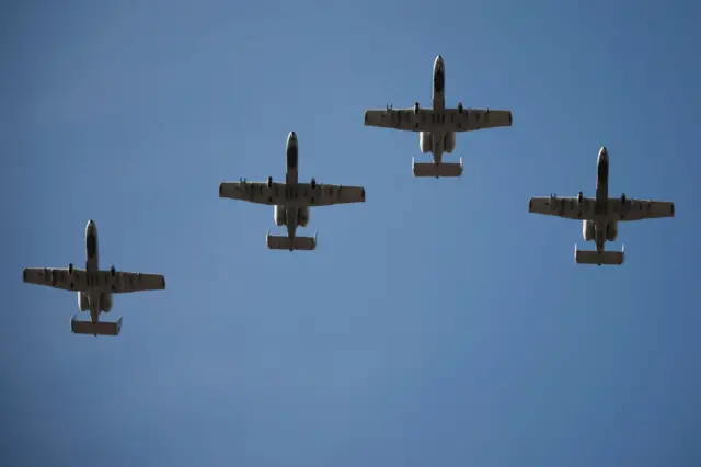 Three military planes fly in the sky