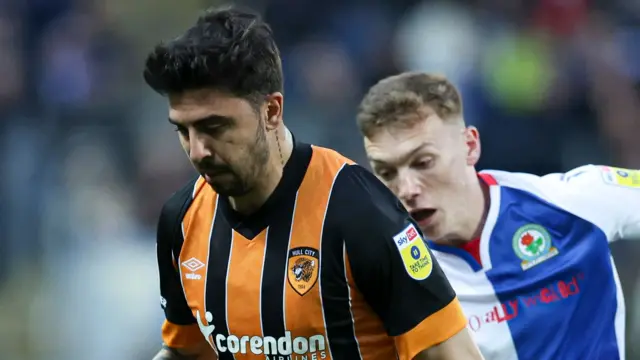 Ozan Tufan beats Blackburn's Hayden Carter to the ball before the latter is booked