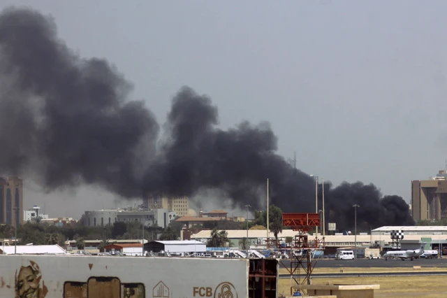 Heavy smoke above buildings in the vicinity of the Khartoum's airport on 15 April 2023