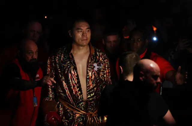 Zhilei Zhang enters the ring in a golden robe