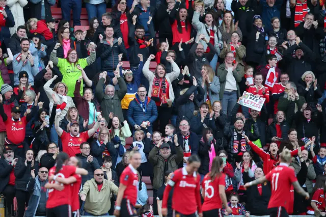 Manchester United fans celebrate with the players after reaching the final of the Women's FA Cup