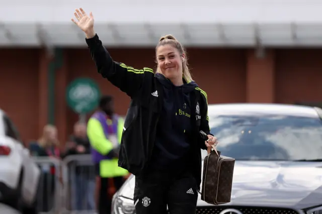 Mary Earps waves at supporters as she enters Leigh Sports Village for Manchester United's game against Brighton