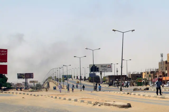 Smoke rises above buildings in Khartoum on 15 April 2023 amid reported clashes in the city