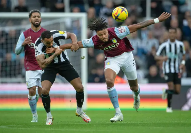 Callum Wilson and Tyrone Mings challenge for the ball