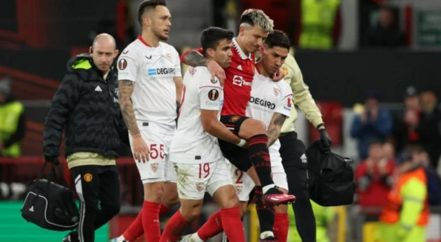 Lisandro Martinez carried from the field on Thursday by Sevilla players