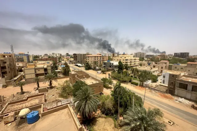 Smokes rise after clashes erupted in the Sudanese capital on April 16, 2023