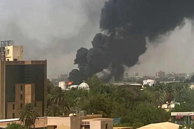 Smoke billows above residential buildings in Khartoum on 16 April 2023