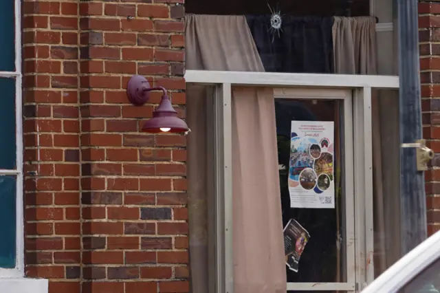 A bullet hole is visible above a door at the Mahogany Masterpiece dance studio