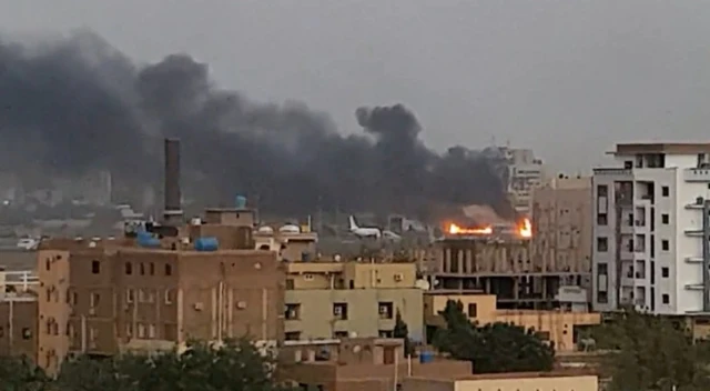 Smoke billows across the sky from a fire near the Khartoum International Airport