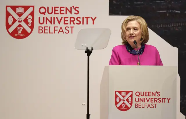 Hillary Clinton stands at a Queen's University Belfast lectern