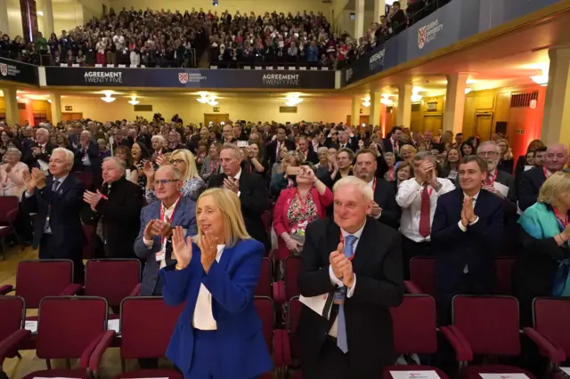 The crowd at Queen's University give George Mitchell a standing ovation