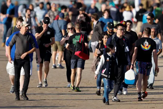 People leave the scene of the postponed launch of Starship