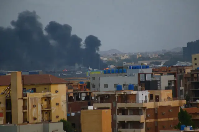 Smoke rises above rooftops in Khartoum