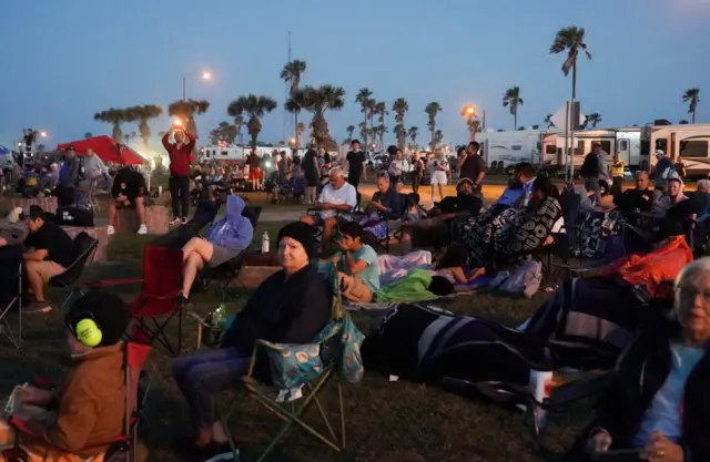 Spectators gather near the launch site in Texas