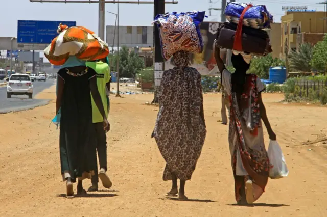 People flee from southern Khartoum on April 18, 2023 as fighting between the army and paramilitary forces led by rival generals rages for a fourth day