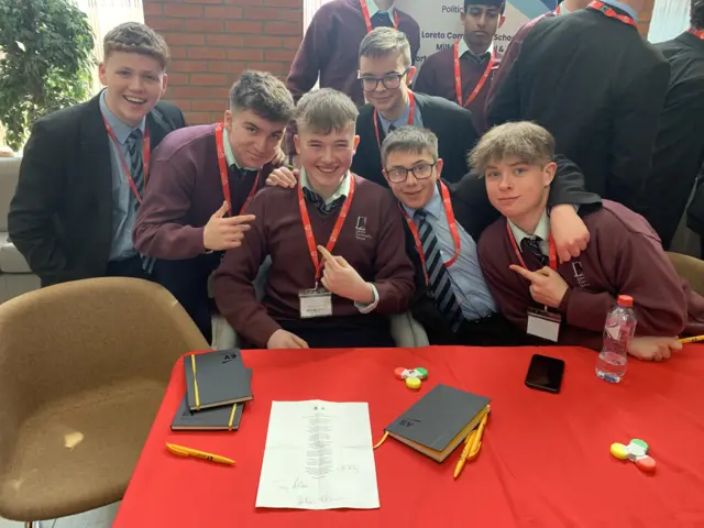 Young poet Jack poses with other pupils for a photo