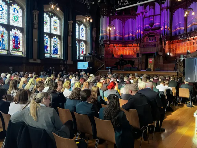 Audience members taking their seats in Derry's Guildhall