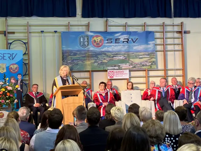 Hilary Clinton speaking at lectern