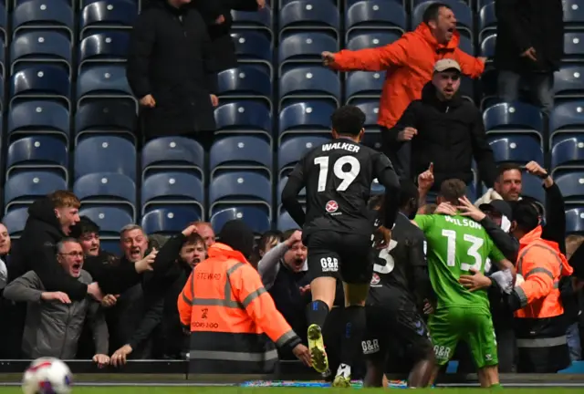 Ben Wilson celebrates with the fans after his late equaliser