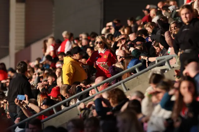 United fans bask in the sunshine.