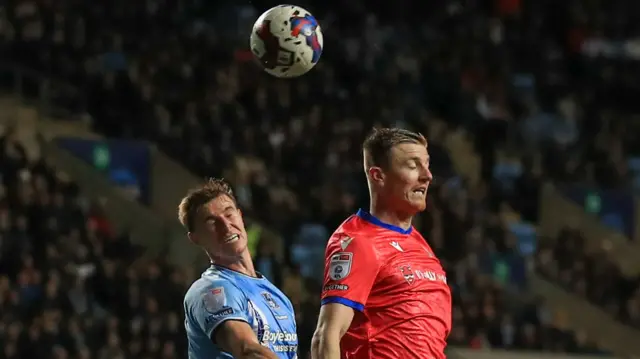 Scott Wharton and Michael Rose rise to attack a corner