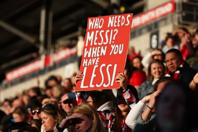 A fan holds up a sign in support for Alessia Russo.