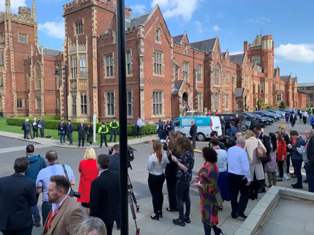 Members of the press outside Queen's University