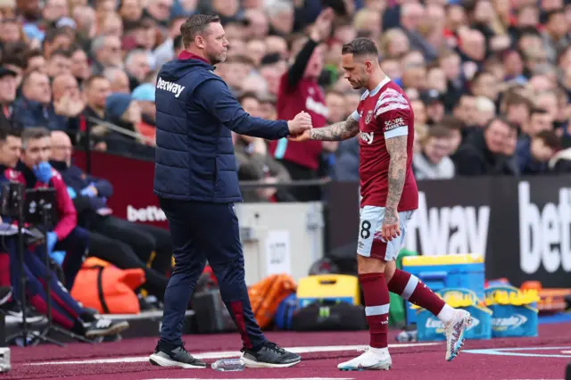 Kevin Nolan, first team coach of West Ham United shakes hands with Danny Ings of West Ham United after being substituted