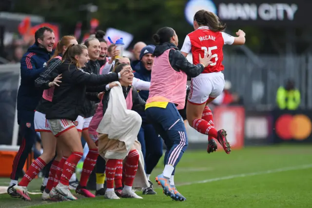 Katie McCabe of Arsenal celebrates with teammates after scoring the team's second goal