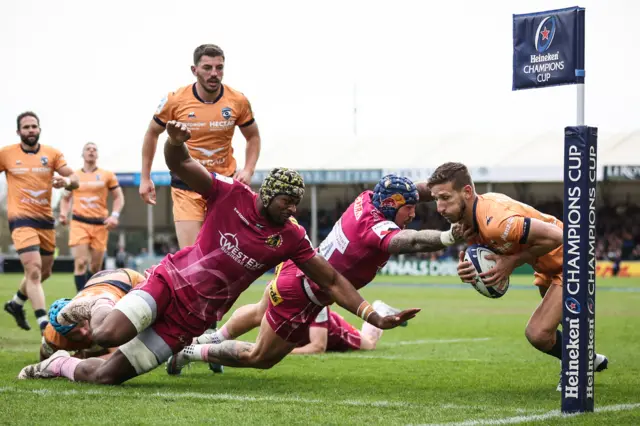 Montpellier wing Vincent Rattez is tackled by Exeter Chiefs' Jack Nowell and Christ Tshiunza