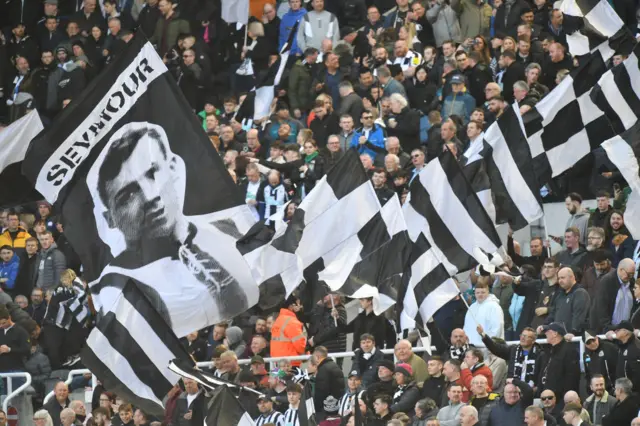 Newcastle United fans waving flags during the Premier League match between Newcastle United and Manchester United at St. James Park