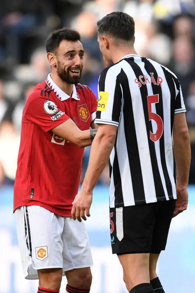 Manchester United's Portuguese midfielder Bruno Fernandes and Newcastle United's Swiss defender Fabian Schar have words