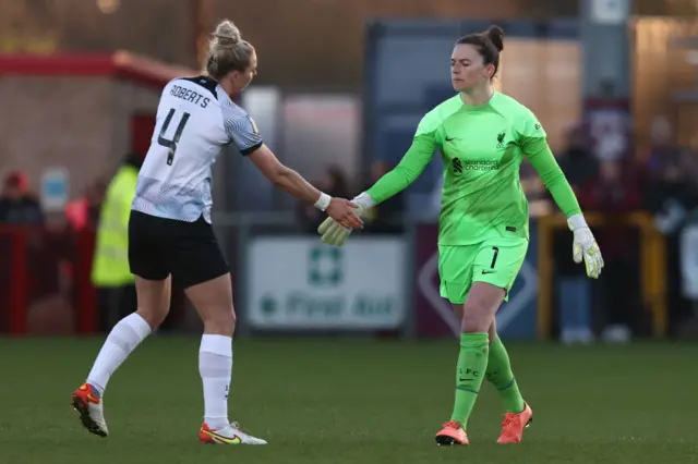 Rachael Laws and Rhiannon Roberts of Liverpool congratulate each other