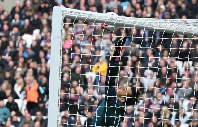 West Ham United's Polish goalkeeper Lukasz Fabianski reaches up as the ball comes back off the crossbar following a header from Southampton's Nigerian striker Paul Onuachu