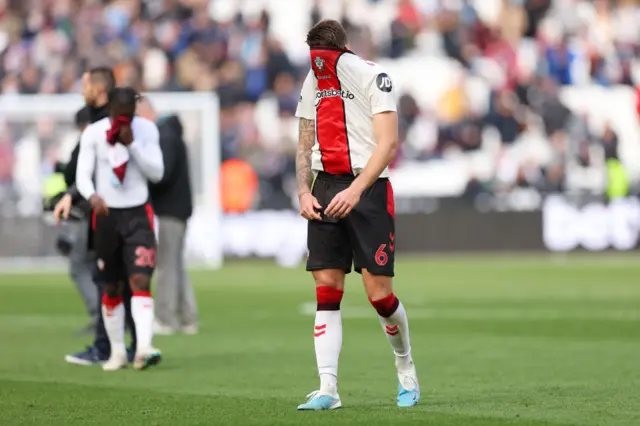 A dejected Duje Caleta-Car of Southampton wears his shirt over his head