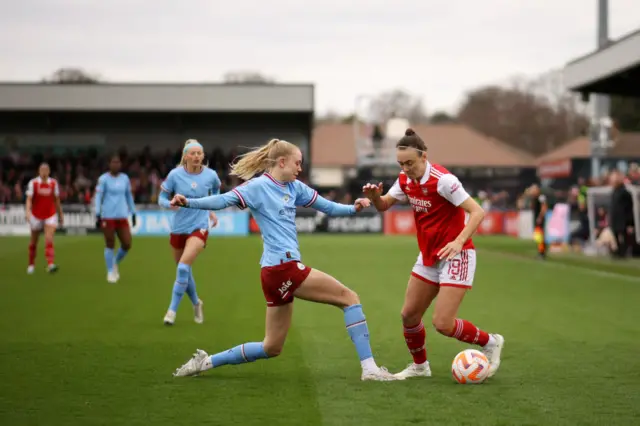 Caitlin Foord of Arsenal battles for possession with Esme Morgan