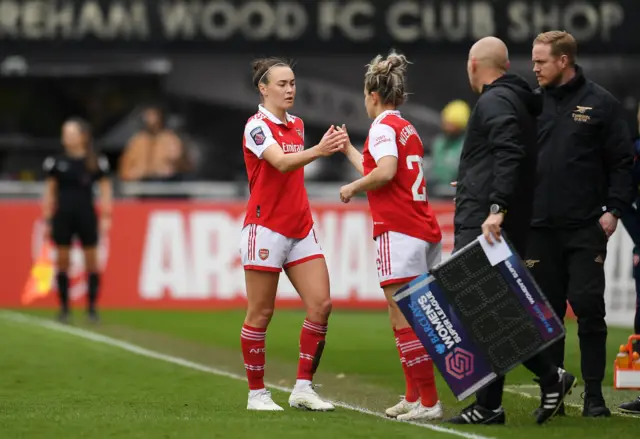 Caitlin Foord of Arsenal comes off the pitch and shakes the hand of Laura Wienroither