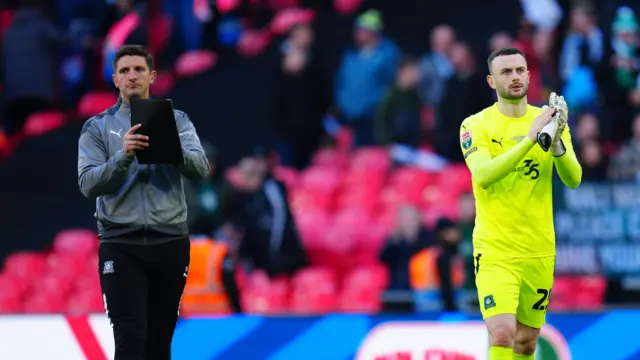 Dejected Plymouth players and staff