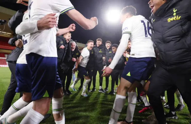 Tottenham Hotspur U17 manager Stuart Lewis celebrates with players and staff following the U17 Premier League Cup Final match between Nottingham Forest and Tottenham Hotspur at City Ground on April 19, 2023