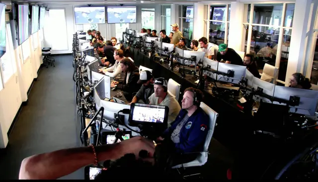 A handout livestream video released by SpaceX showing Elon Musk (C, front) in the command center during the launch of inaugural test flight of Starship