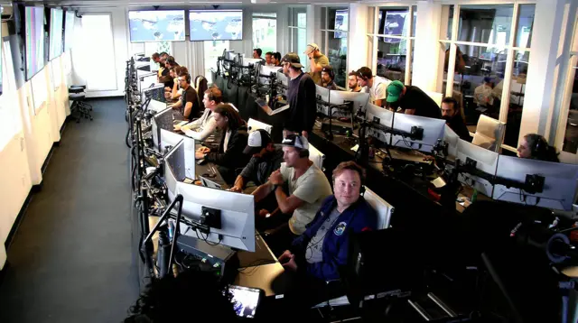 A handout livestream video released by SpaceX showing Elon Musk (C, front) in the command center during the launch of inaugural test flight of Starship