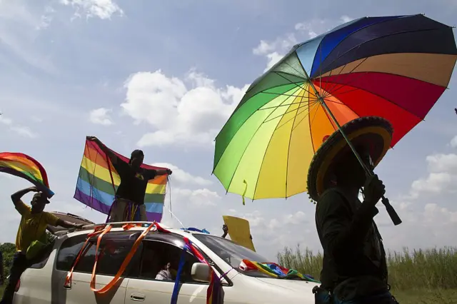 People in Uganda holding pride flags