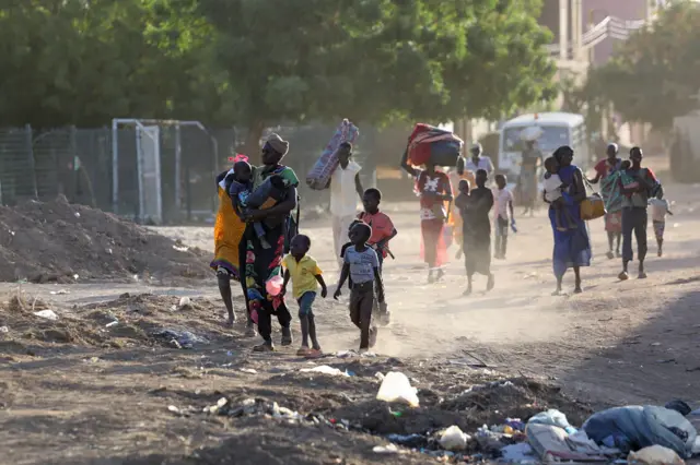 People flee their neighbourhoods amid fighting between the army and paramilitaries in Khartoum on April 19, 2023