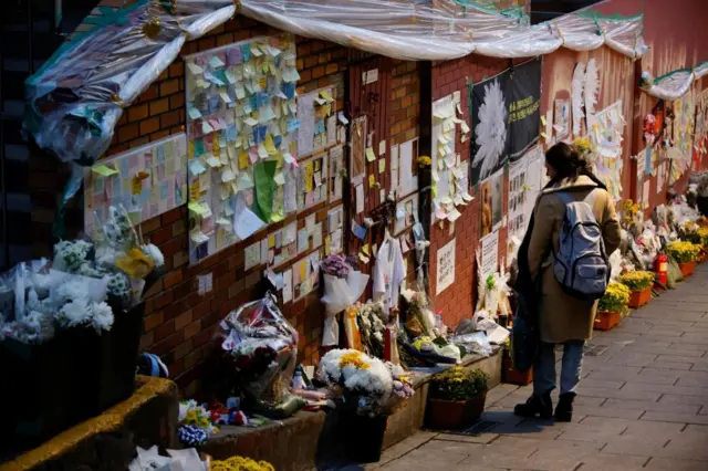 A woman mourns at the scene of a crowd crush that happened during Halloween festivities, in Seoul, South Korea