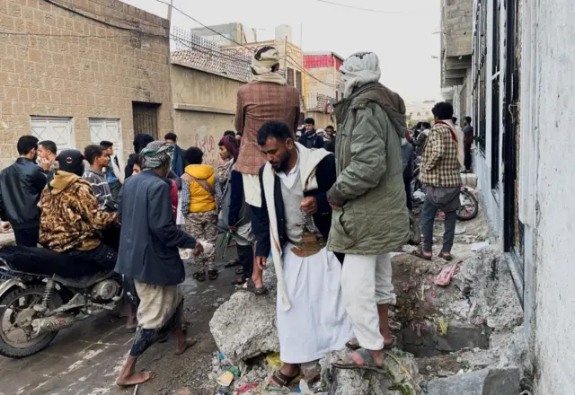 People waiting outside the school in Sanaa