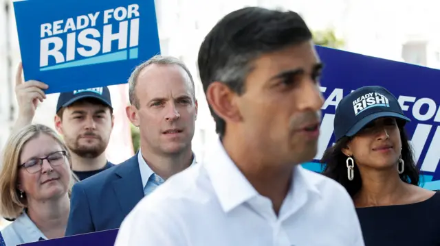 Dominic Raab looks at then Tory leadership candidate Rishi Sunak during a campaign event last August