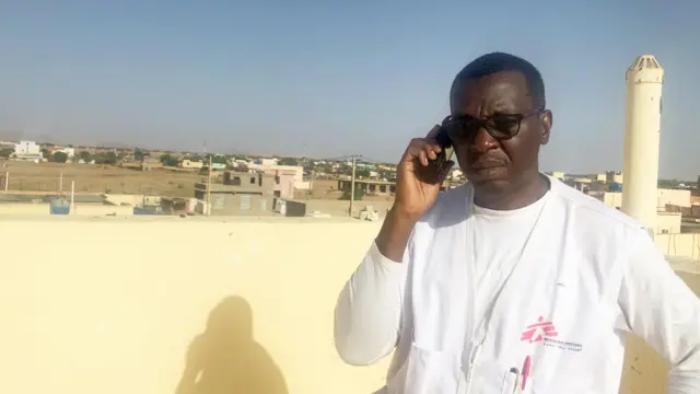 Cyrus Paye on the phone in Fasher, North Darfur, Sudan - April 2023